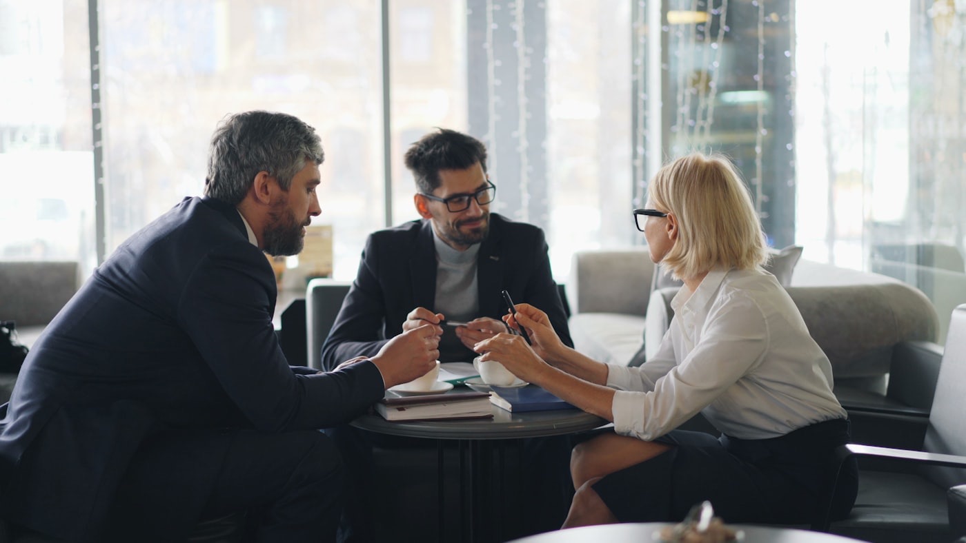 Advisers in discussion around a table